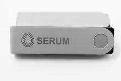 Silver Ledger Nano X hardware wallet engraved with the Serum logo, on a white background.