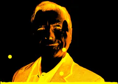 Animated orange duotone portrait of a smiling gray-haired man in a collared shirt, with small yellow dots, on black.