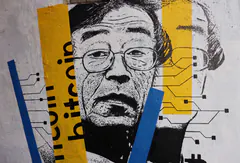 Photo of a street mural of a man in glasses, with yellow and blue stripes and the word bitcoin painted across it.